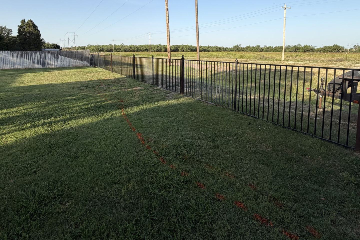 Before: lawn running up to an iron fence
