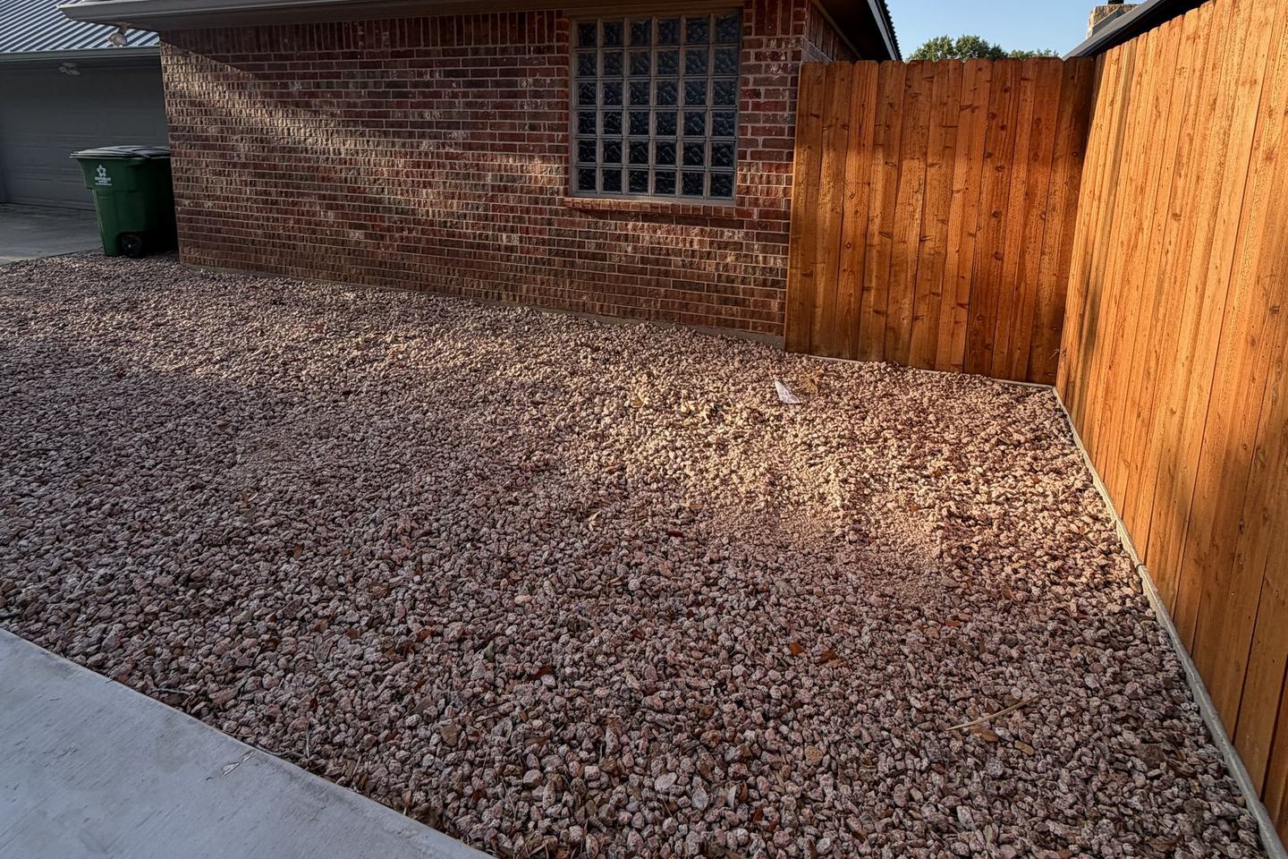 After: the same side yard finished in decorative rock